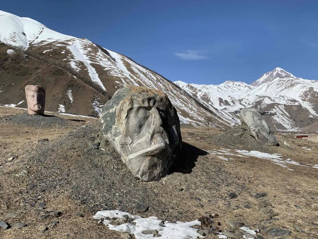 The carved Sno Heads are a quirky thing to see in Kazbegi